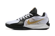 Side profile showing a gold Swoosh and white-and-black upper