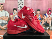 Angled view of red Nike basketball sneakers showing the side branding, textured upper, laces, and outsole.