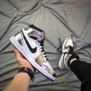 Side view highlighting the silver overlays, white panels, black Swoosh, and blue outsole.