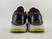 Rear view of both shoes with dark heel counters and green signature details.