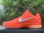 Opposite side profile showing the orange Nike Kobe 6 sneaker and silver Swoosh detail.