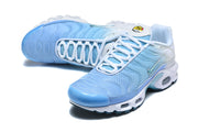 Pair of light blue and white Nike Air Max Plus sneakers shown from above.