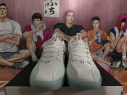 Front view of the white Nike basketball sneakers showing the perforated toe boxes, laces, and light blue-green outsole details.