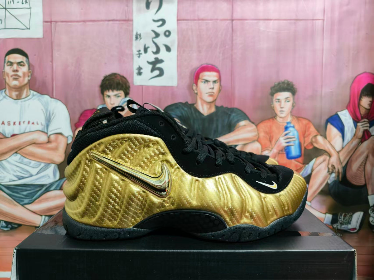 Side view of a gold and black Nike basketball sneaker with a textured metallic-look upper and black outsole.