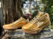 Pair of gold Kobe 5 shoes shown from front and side