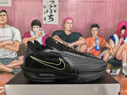 Side view of a black Nike basketball sneaker showing the light-colored Swoosh-style mark, ribbed upper, and visible ZoomX midsole text.