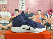Side view of a navy Nike Hyperdunk shoe with a black Swoosh and white sole