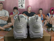Rear view of white Nike sneakers showing pull tabs, heel panels, and tonal heel detailing.