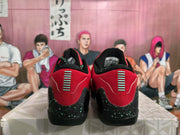 Rear view of red and black Nike basketball sneakers with speckled black heel panels and contrasting heel details.