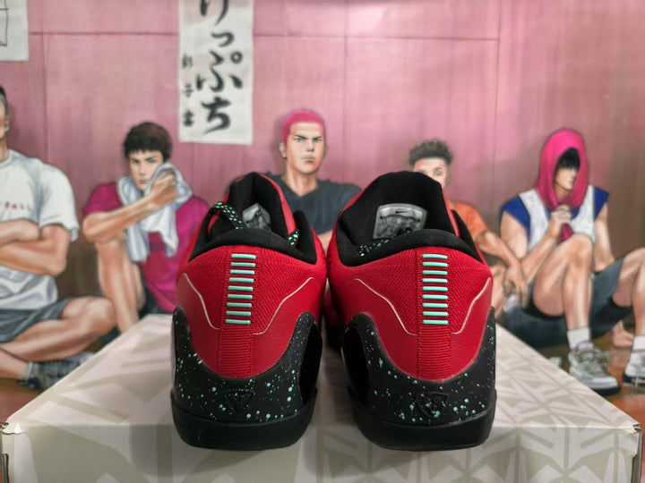 Rear view of red and black Nike basketball sneakers with speckled black heel panels and contrasting heel details.