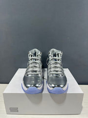 Front view of the pair showing the high-top shape, white laces, and reflective silver toe boxes.