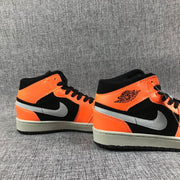 Close view of the orange ankle panels, black collars and grey Swooshes.