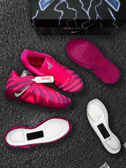Pink and purple sneaker pair arranged with separate soles and exposed underside components.