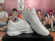 Angled view of paired white Nike basketball sneakers displaying the textured uppers, padded collars and white midsoles.