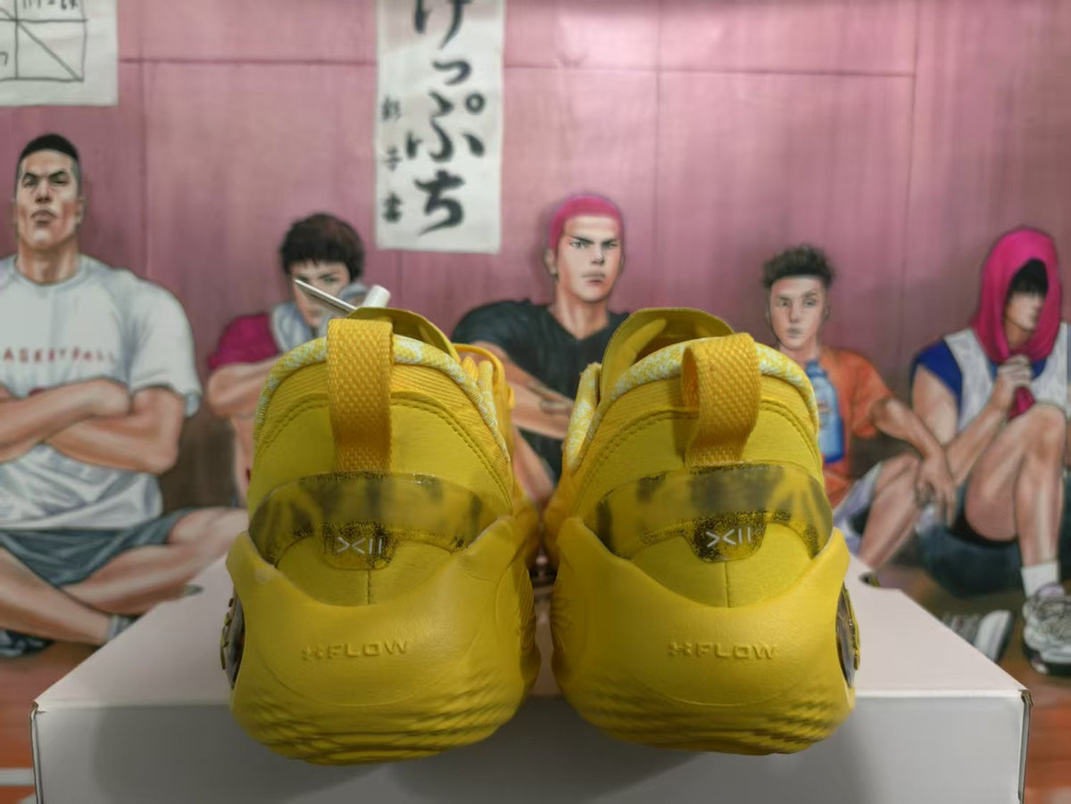 Rear view of yellow sneakers showing padded heel collars, pull tabs, embossed heel details, and translucent midsole sections.