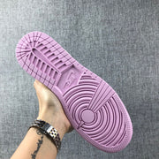 Underside view showing the pink outsole tread pattern and circular pivot detail.
