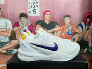 Side view of a white Nike basketball sneaker with purple Swoosh branding and yellow heel details.