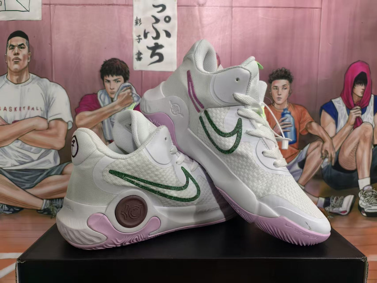 Pair of white Nike KD basketball sneakers with green side detailing, purple accents, and padded high-top collars.