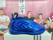 Side profile of a royal blue Nike basketball shoe with a sculpted molded upper.