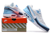 Nike Air Max sneakers in white, light blue and navy displayed beside a Nike Air box.