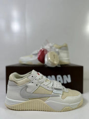 Three-quarter product view showing the cream and white upper, red spare laces, and gray heel detailing.