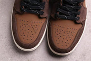 Close-up of the brown perforated toe boxes and surrounding darker brown panels.