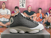 Side view showing the perforated black panel, gray sections, and sculpted outsole.