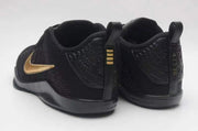 Rear view of the black Kobe 11 shoes showing heel details and gold accents.