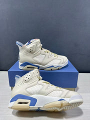 Angled close view showing the stitched side panels, blue midsole accents, and outsole tread.