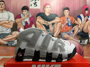 Side view showing bold AIR lettering on a grey and white high-top sneaker