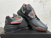 Basketball shoes displayed at an angle, showing the midfoot strap, multicolor accents, and translucent-looking outsole.