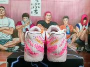 Rear view of white Nike basketball-style sneakers with pink detailing and translucent outsoles.