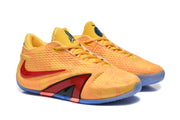 Pair of yellow and orange basketball shoes shown from a front-side angle