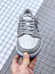 Front view highlighting the white perforated toe panel, grey overlays, and grey laces.