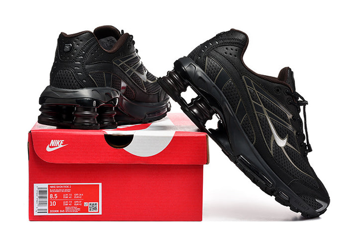Black Nike Shox Ride 2 sneakers displayed with a red shoe box; the box label shows sample sizes 8.5 and 10.