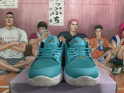 Front view of teal lace-up basketball sneakers with white soles, Jordan-style tongue logos, and red-and-gold tongue details.