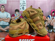 Angled view of the wheat-toned sneakers with visible heel cushioning