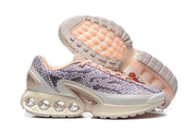 Side and outsole views of Nike Air Max DN sneakers with a patterned upper and cream sole