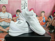 Angled view of the pair of white Nike basketball sneakers showing the side branding, signature detailing, and outsole.