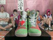 Front view showing the pair's mismatched green and coral-red toe sections, white laces, and multicolor tongue details.