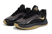 Pair of black and gold Nike Giannis Immortality 7 basketball shoes
