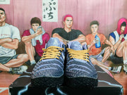 Front view of blue and purple basketball shoes with gold-tone laces and textured black outsoles.