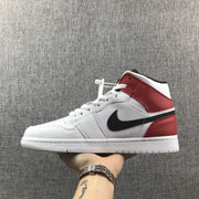 Lateral side view highlighting the red ankle and heel panels with black side branding.