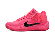 Side profile of a pink Nike basketball sneaker showing the black Swoosh, layered upper and sculpted sole.
