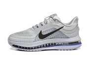Side view of a light grey Nike Pegasus Premium shoe with black Swoosh and blue sole accents