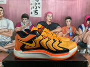 Side profile of an orange and black sneaker showing the black Swoosh, layered side structure, and white midsole.
