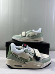 Close side view of the sneaker pair showing the padded white collar, forefoot strap, and floral details.