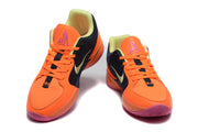 Pair of orange, black, pink, and lime Jordan basketball sneakers shown from the front.