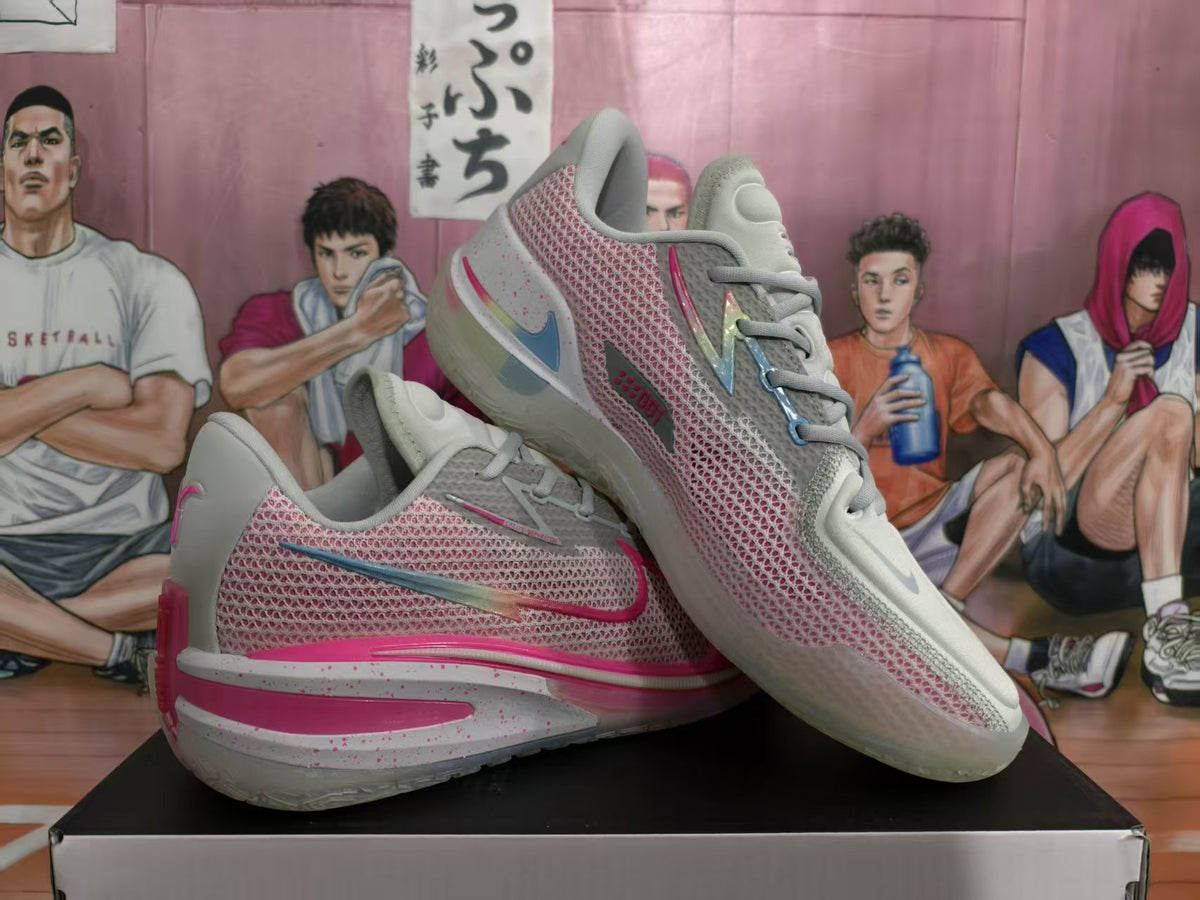 Pair of white, pink, and gray Nike sneakers shown from the side on a box.