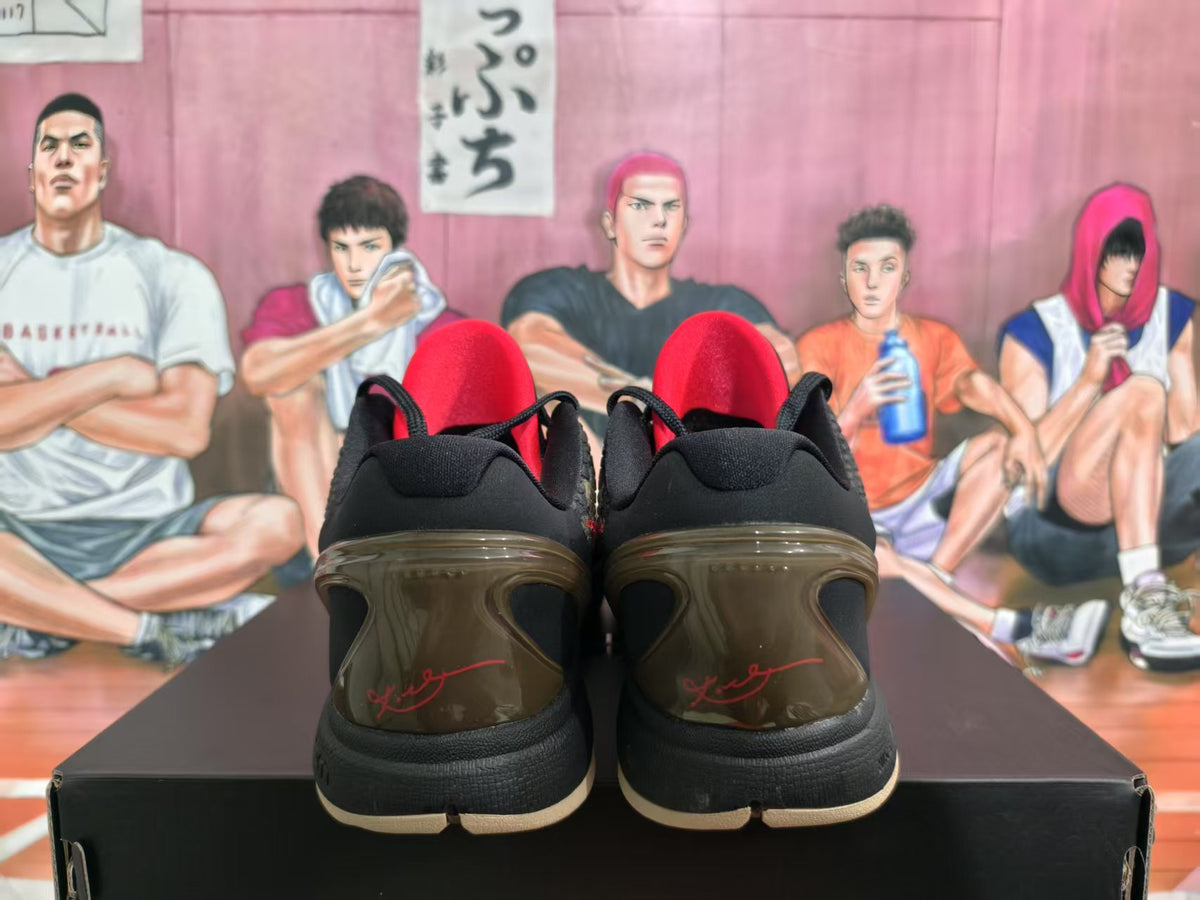 Rear view of Nike Kobe camouflage sneakers showing black collars, red accents and translucent brown-toned heel sections.
